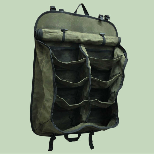 Green backpack with multiple pockets on a white background